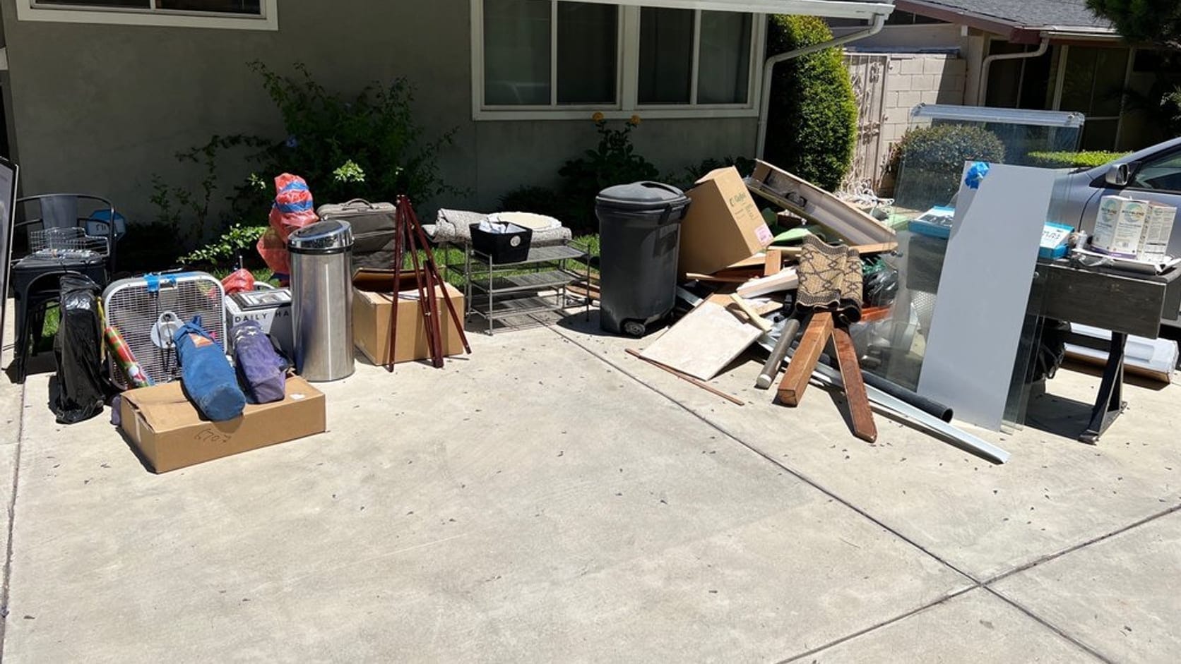 Household junk, furniture and boxes piled on a driveway outside a Palm Bay home ready for removal