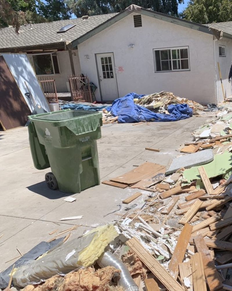 Renovation debris stacked for construction debris removal at a Palm Bay job site