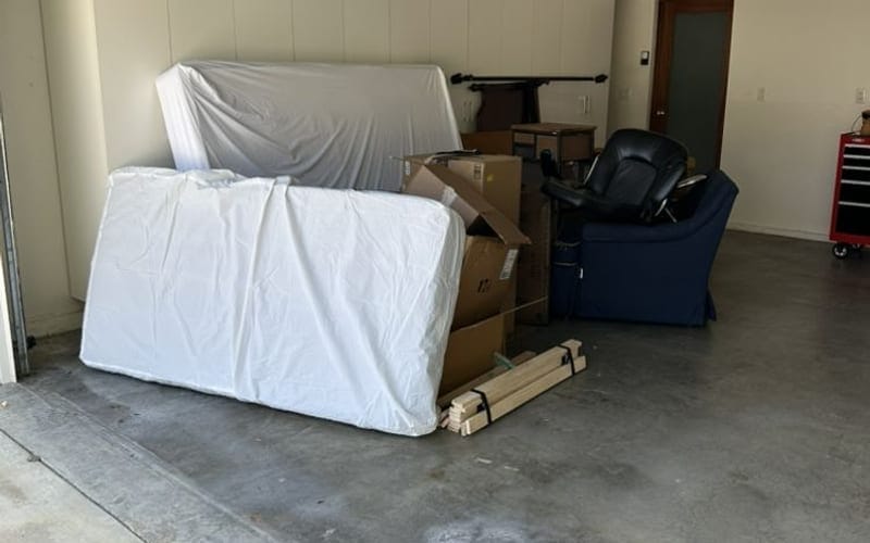 Wrapped mattress ready for collection from a Palm Bay garage