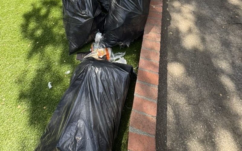 Bagged junk left at the curb after a rental turnover in Palm Bay