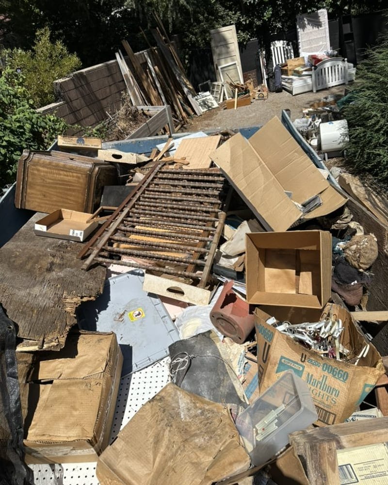 Cardboard, furniture and household junk stacked on a Palm Bay driveway